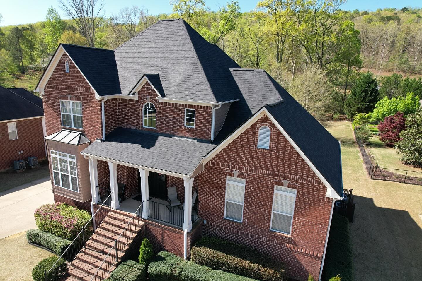 Roofing team discussing project planning phases onsite.